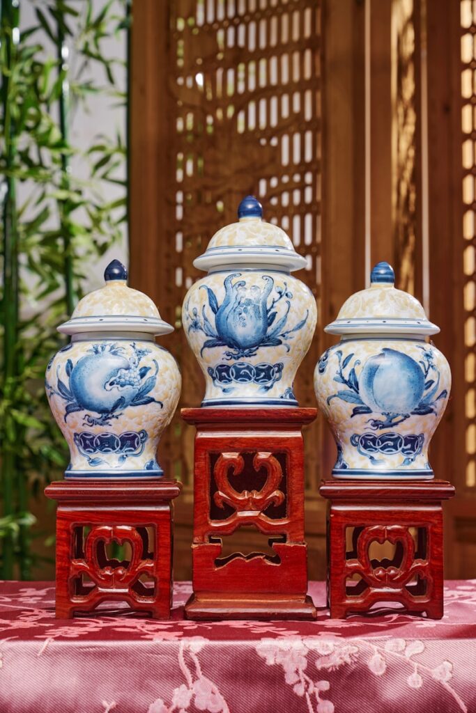 Three blue and white vases sitting on top of a table