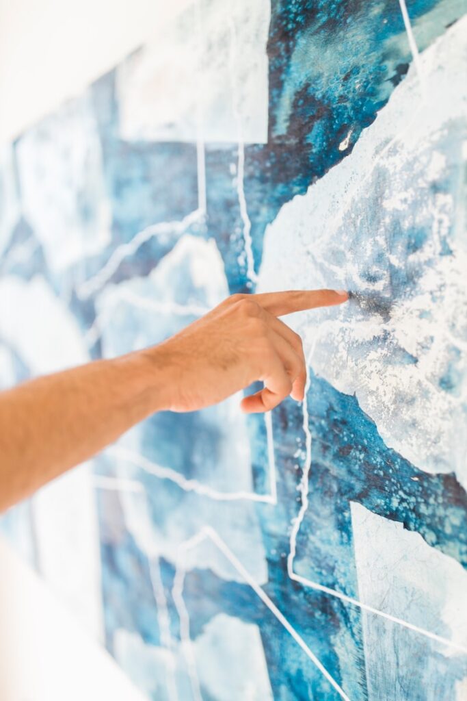 person holding blue and white paint