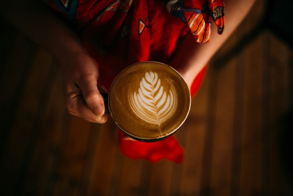 a person holding a cup of coffee in their hands
