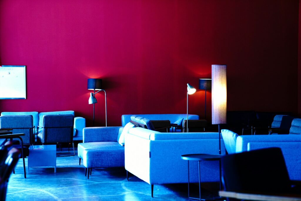a room with a couch and chairs